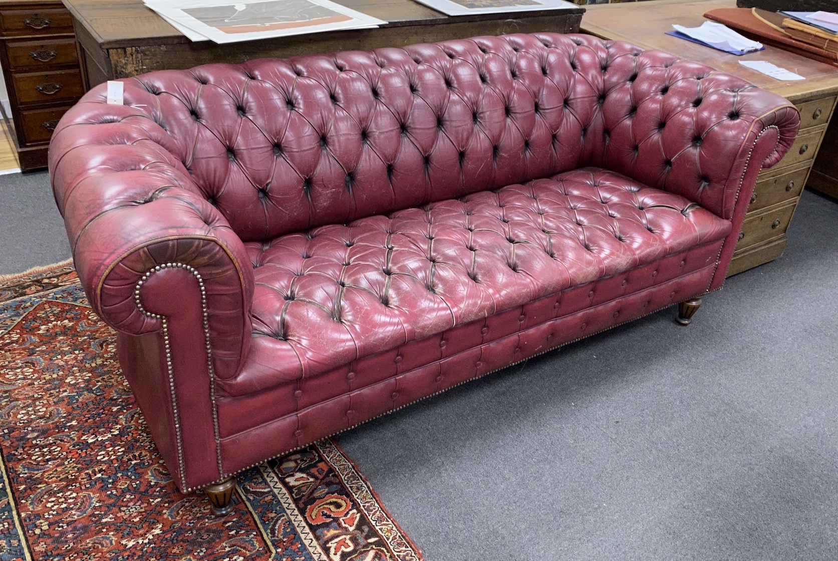 A Victorian style buttoned burgundy leather Chesterfield settee, length 210cm, depth 90cm, height 82cm
